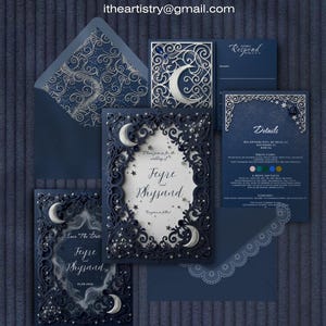 May include: A dark blue wedding invitation suite featuring intricate laser-cut frames with silver crescent moons and stars. The set includes a main invitation, a save the date card, a details card, and envelopes with decorative liners and text.