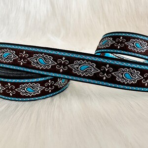 May include: Brown and blue paisley patterned ribbon trim with silver accents.