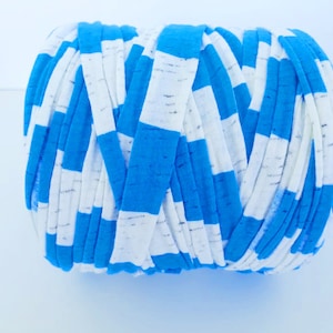 May include: A roll of blue and white striped t-shirt yarn. The yarn is made from recycled t-shirts and is perfect for crocheting or knitting.