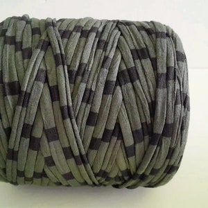 May include: A roll of green and black striped yarn. The yarn is made of a soft, stretchy material and is perfect for crocheting or knitting.