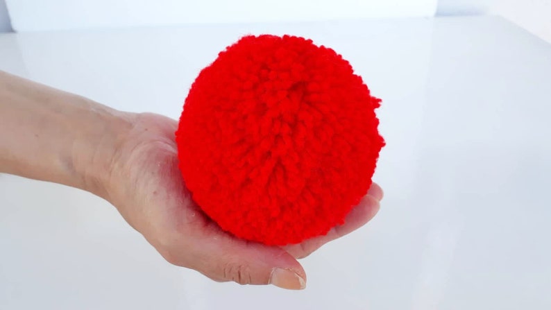 red yarn pom poms