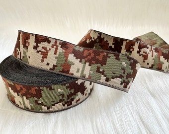 May include: A roll of brown, green, and white camouflage ribbon with a black edge.