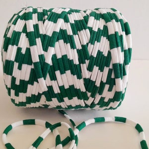 May include: A roll of green and white striped yarn. The yarn is made of a soft, stretchy material and is perfect for crocheting or knitting.