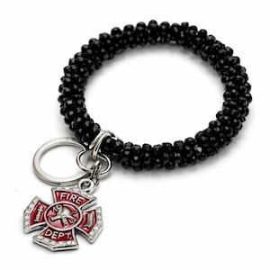 May include: A black beaded bracelet with a silver keyring and a firefighter-themed charm. The charm is a red and silver Maltese cross with the words "FIRE DEPT" and a firefighter's emblem.