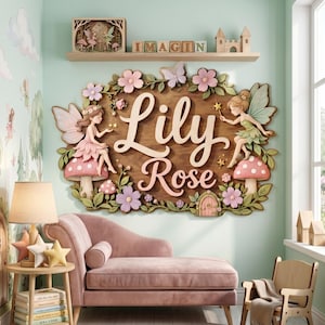 May include: A wooden wall sign featuring the name Lily Rose in cream-colored script lettering, surrounded by 3D-style fairy figures, pink mushrooms, and pastel flowers. The sign is mounted on a light green wall above a pink velvet chaise lounge.