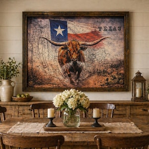May include: A framed artwork featuring the Texas flag and a longhorn steer. The artwork is displayed above a wooden sideboard in a dining room setting. The room includes a wooden dining table, chairs, and decorative elements.