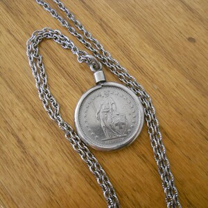 Vintage 1968 Helvetica coin with 24 inch chain.  Vintage silver accessory.  Collectible coin.