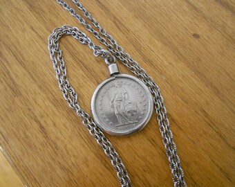 Vintage 1968 Helvetica coin with 24 inch chain.  Vintage silver accessory.  Collectible coin.