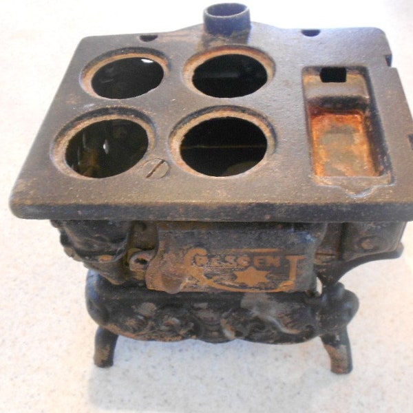 Vintage Crescent cast iron toy stove.  Home decor.