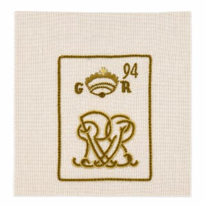 May include: Square, off-white fabric with a gold embroidered design. The design includes a crown, the letters "G" and "R", the number "94", and intertwined letters. The border is also gold.