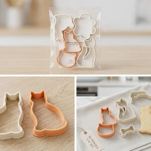 May include: A collection of cat-shaped cookie cutters, some orange and some white, in a clear bag. The set includes different cat silhouettes and a bone shape. The text "GENTLE REMINDERS CAT CUTTER SET" is visible on the packaging.