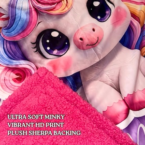 May include: A white ceramic mug with a black handle and the text "But First, Coffee" in a bold, black font. The mug is set against a blurred background, suggesting a cozy setting.