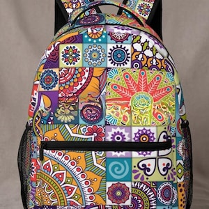 May include: A colorful backpack with a patchwork design featuring geometric and floral patterns in shades of red, orange, yellow, green, blue, and purple. The backpack has a black zipper, mesh side pockets, and black shoulder straps.