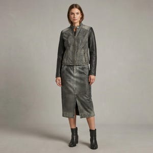 May include: A charcoal gray leather jacket with a stand-up collar, long black sleeves, and a front zipper closure, paired with a matching charcoal gray midi-length leather skirt featuring a central front slit and visible seam detailing.