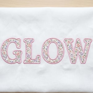 May include: A rustic wooden sign with the text "Welcome to our home" in white lettering. The sign features a distressed finish and a simple, inviting design, perfect for entryway decor.