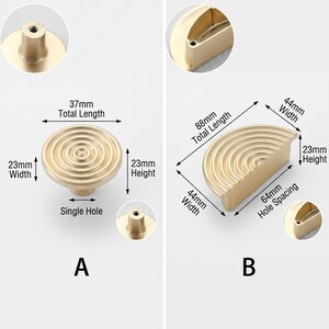 May include: Two gold-coloured metal cabinet knobs with concentric circular ridges. Option A is a circular knob with a 37mm total length, 23mm width, and 23mm height. Option B is a semi-circular handle with 88mm total length, 44mm width, 23mm height, and 64mm hole spacing.