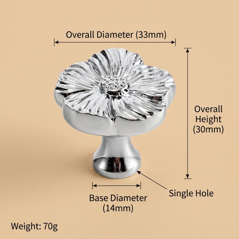 May include: A silver-coloured flower-shaped cabinet knob with a reflective finish. The knob has an overall diameter of 33mm, an overall height of 30mm, a base diameter of 14mm, a single hole for mounting, and a total weight of 70g as labelled.