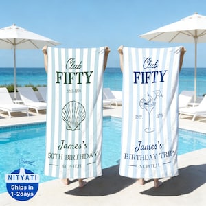 May include: Two beach towels with blue and white stripes are held up in front of a pool and ocean. One towel has a seashell graphic and text that reads "Club FIFTY" and "James's 50th Birthday". The other towel has a cocktail graphic and text that reads "Club FIFTY" and "James's Birthday Trip".