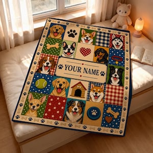 May include: A rectangular throw blanket featuring a grid of various dog breeds, paw prints, bones, and a central rectangular panel with the text YOUR NAME. The design includes colorful patterns like plaid, stars, and polka dots on a cream background.