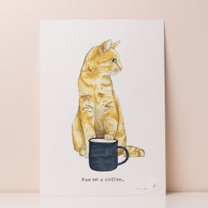 May include: A watercolor illustration of an orange tabby cat holding a black coffee mug. The cat is looking to the right and the text "Paw me a coffee." is below the mug.