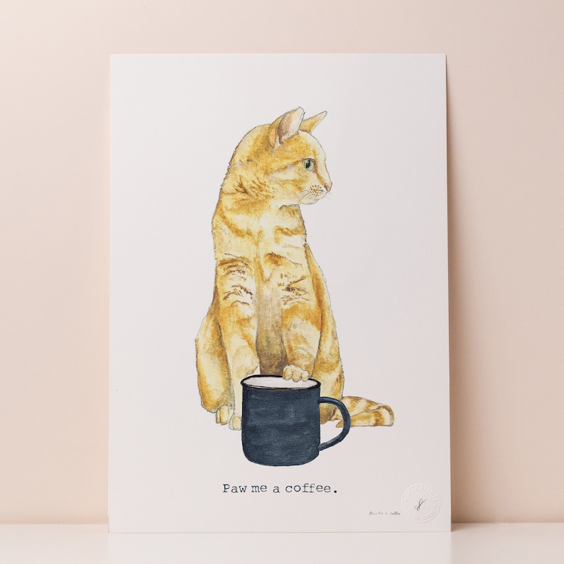 May include: A watercolor illustration of an orange tabby cat holding a black coffee mug. The cat is looking to the right and the text "Paw me a coffee." is below the mug.
