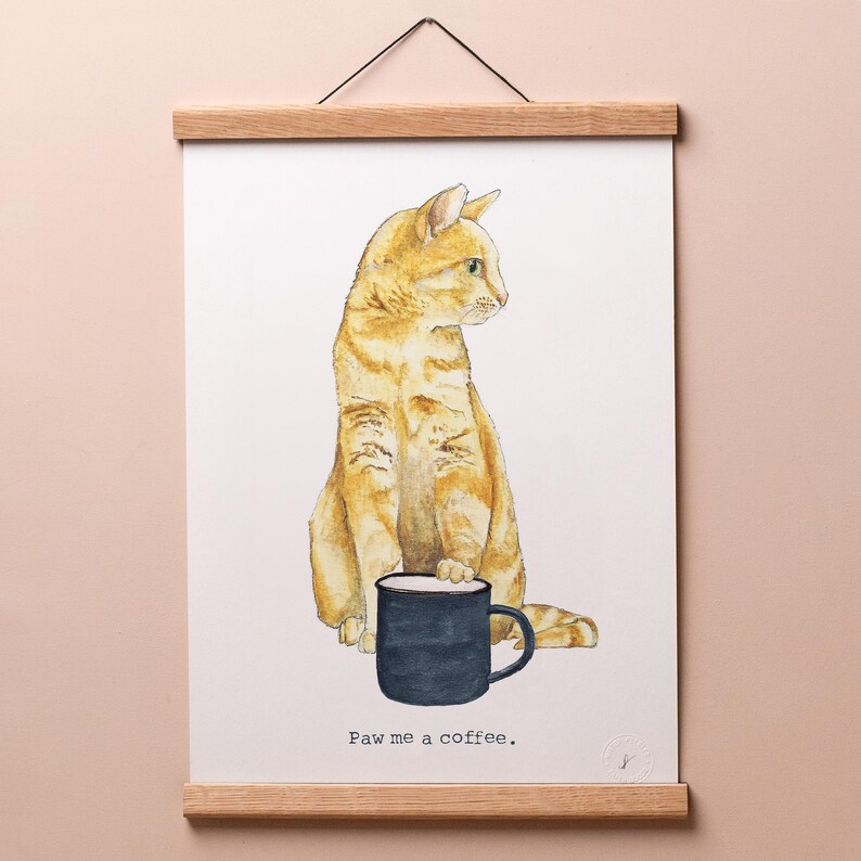 May include: A watercolor illustration of an orange tabby cat holding a black coffee mug. The cat is sitting on a white background and the text "Paw me a coffee." is below the cat.