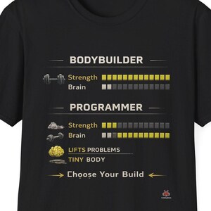 May include: Black t-shirt with a humorous graphic comparing a bodybuilder and a programmer, with strength and brain power bars. The text reads "Choose Your Build" with a small logo.