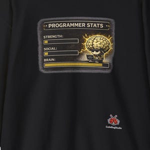 May include: Black sweatshirt with a graphic of a brain and the text "PROGRAMMER STATS". The graphic includes bars for strength, social, and brain. The sweatshirt has long sleeves and a crew neck.