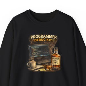 May include: Black sweatshirt with a graphic that reads "PROGRAMMER DEBUG KIT." The design includes a laptop displaying code, a cup of coffee, a glass of whiskey, and a bottle labeled "Refactor Juice."