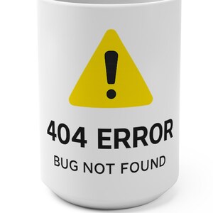 May include: White ceramic coffee mug with a yellow triangle warning symbol and black exclamation point. The mug has the text "404 ERROR BUG NOT FOUND" in black font. The mug is cylindrical and sits on a white surface.