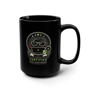 May include: Black ceramic mug with a cartoon bug wearing glasses and a laptop, and the text "CERTIFIED BUG ENGINEER". The bug is inside a circular design with stars and a checkmark.