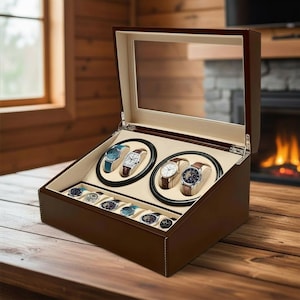 May include: A dark brown wooden watch winder box with a glass lid, featuring two circular rotating slots for automatic watches and a lower storage tray with six compartments for additional timepieces, all lined with a light beige interior.