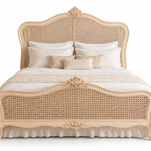 May include: A light-coloured wooden bed frame featuring a curved headboard and footboard with woven cane panelling. The frame is adorned with carved floral details at the centre of the headboard and footboard, dressed with white bedding and pillows.