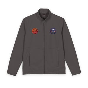May include: Charcoal gray zip-up jacket with two front pockets. Features a basketball patch on the left chest and a circular emblem on the right chest. The jacket has a stand-up collar and a full-length zipper.