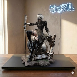 May include: A detailed figurine of a character in a black dress, thigh-high boots, and a white bob haircut, holding a sword. The figure is posed on a metallic structure, with the neon sign "kingSTL" in the background. The base is black.