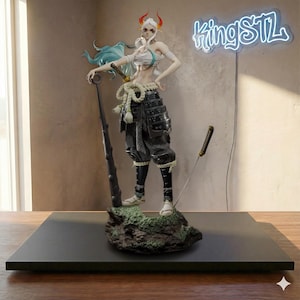 May include: A detailed figurine of a character with white hair, red horns, and blue accents, dressed in black armor and holding a staff and a sword. The figurine stands on a mossy base atop a black platform. The neon sign in the background says "kingSTL".