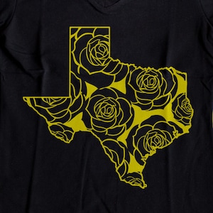 May include: Black t-shirt with a yellow outline of the state of Texas filled with a floral pattern.