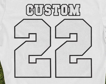 May include: White t-shirt with black text that says "CUSTOM" and the number "22" in a large font.