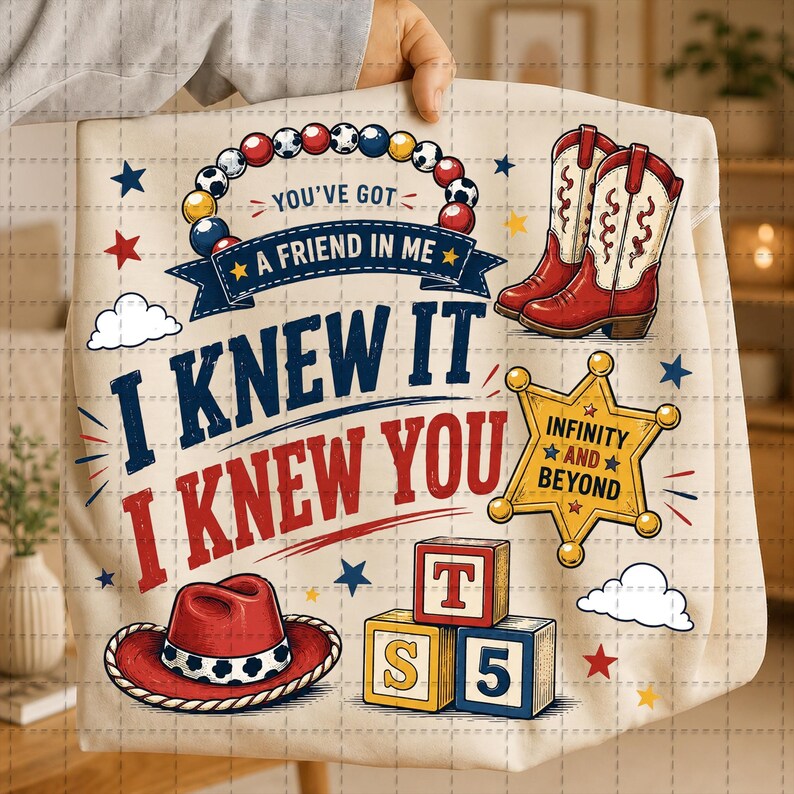 May include: A cream-colored fabric item featuring a graphic print with red cowboy boots, a red cowboy hat, a yellow sheriff star badge, and three alphabet blocks labeled T, S, and 5. The text reads You've Got A Friend In Me, I Knew It, I Knew You, and Infinity And Beyond.
