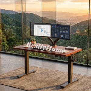 May include: A standing desk with a dark wood-grain surface and black metal legs, featuring two computer monitors mounted on an adjustable arm, a keyboard, a small potted plant, books, and headphones hanging from the side, with the text RestlyHome.