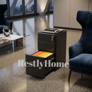 May include: A matte black metal mobile filing cabinet with three drawers, featuring a silver lock with a key inserted in the top drawer. The bottom drawer is open, revealing orange and yellow hanging file folders. The text RestlyHome is visible.