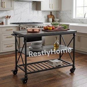 May include: A kitchen island cart with a dark gray wood-grain top and a black metal frame featuring X-shaped side supports and four caster wheels. The cart includes a middle shelf with a stack of plates and a glass oil cruet, and a bottom slatted shelf.