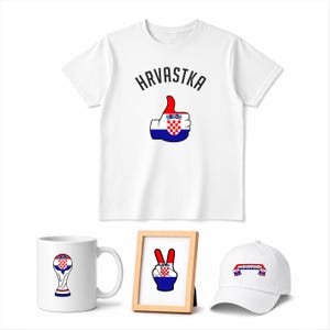 May include: A collection of Croatian-themed merchandise, including a white t-shirt with "Hrvatska" and a thumbs-up graphic in Croatian flag colors. Also, a white mug, a framed peace sign, and a white baseball cap with a Croatian flag design.