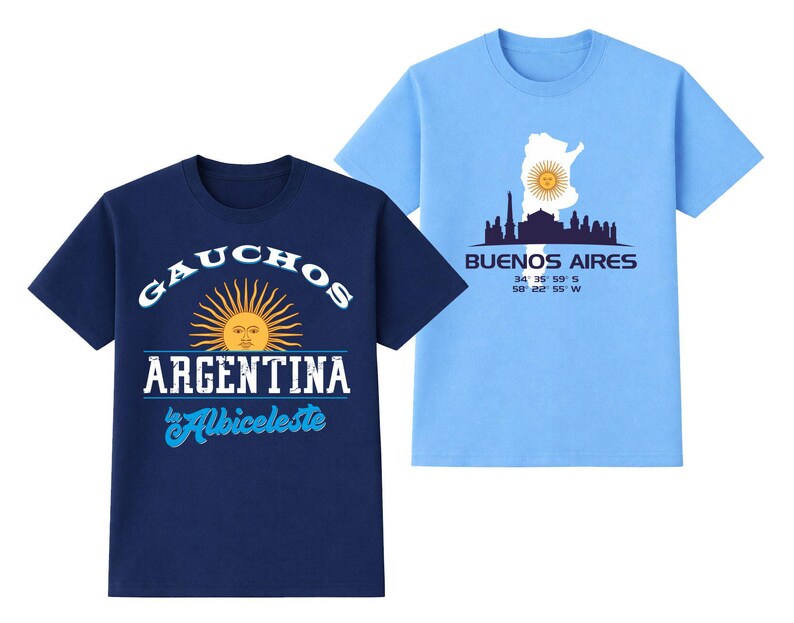May include: Two short-sleeved t-shirts. One is navy blue with "GAUCHOS ARGENTINA" text and a sun graphic. The other is light blue with a Buenos Aires skyline graphic and coordinates. Both shirts are crew neck.