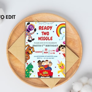 May include: A light blue birthday party invitation with the text "READY TWO WIGGLE" and cartoon characters. The invitation includes the date, time, and location for a 5th birthday celebration. The invitation is on a wooden tray with an envelope.