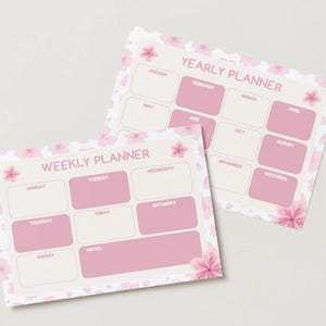 May include: Two pink and white planners, one weekly and one yearly, with floral accents. The weekly planner has boxes for each day and notes. The yearly planner has boxes for each month. The text "WEEKLY PLANNER" and "YEARLY PLANNER" are visible.