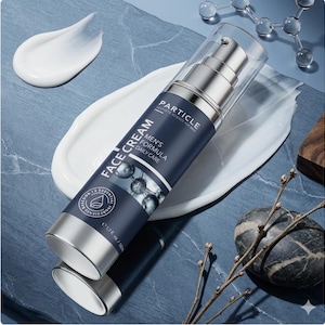 May include: A silver and navy blue face cream bottle with the text "FACE CREAM" and "MEN'S FORMULA DAILY CARE". The bottle is 1.7 fl oz / 50ml. White cream is spread on a blue surface.