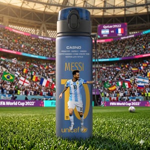 May include: A blue water bottle featuring an image of Lionel Messi in an Argentina soccer uniform. The bottle has the text "MESSI" and "10" in gold, along with the words "CASNO" and "unicef". The background shows a soccer stadium.