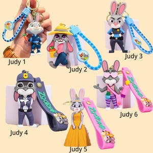 May include: Collection of six Judy Hopps keychains from the movie Zootopia. Each keychain features a different pose and outfit of the character. The keychains have colorful straps with the movie's logo and character art. The keychains are made of a durable material.