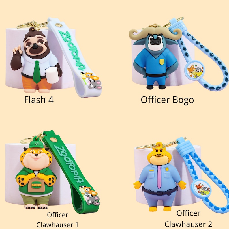 May include: Four Zootopia character keychains. Flash 4 is a sloth with a white shirt, green tie, and orange pants. Officer Bogo is a blue buffalo. Officer Clawhauser 1 is a tiger. Officer Clawhauser 2 is a yellow cat.